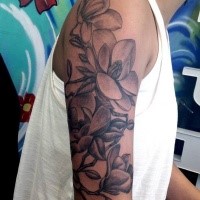 Large realistic looking black and white half sleeve tattoo of various flowers