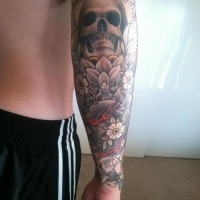 Large skull with flowers forearm tattoo