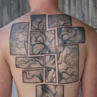 Large tree puzzle tattoo on back