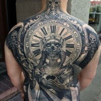 Large whole back tattoo of creepy monster with clock and skulls