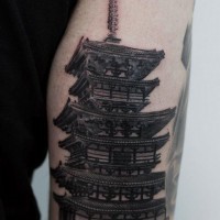 Lifelike black and wite detailed Asian temple tattoo on upper arm