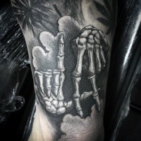 Lifelike black ink tattoo of human skeleton hands