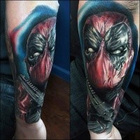 Lifelike colored arm tattoo of evil Deadpool and pistol