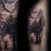 Lifelike colored shoulder tattoo of creepy owl with chess board