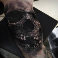 Lifelike detailed biceps tattoo painted by Eliot Kohek of skull