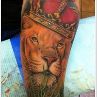 Lion in red royal crown tattoo