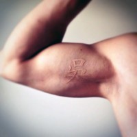 Little 3D like white ink Asian symbol tattoo on arm