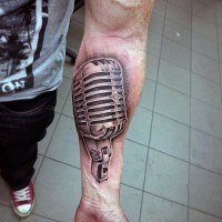 Little 3D style black and white microphone tattoo on arm