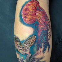 Tatuaje en el brazo, medusa roja maravillosa con tortuga bonita