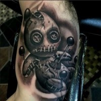 Little black and white creepy voodoo doll tattoo on arm