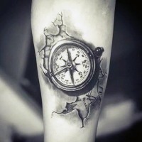 Little black and white detailed compass tattoo on arm