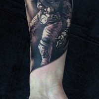 Little black and white detailed spaceman tattoo on wrist
