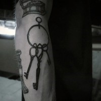 Little black ink antic keys tattoo on arm