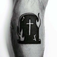 Little black ink burning tombstone tattoo on leg