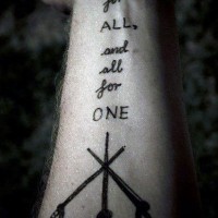 Little black ink crossed swords with lettering tattoo on arm