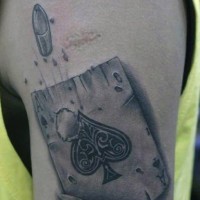 Little black ink detailed ace of spades with bullet hole tattoo on upper arm