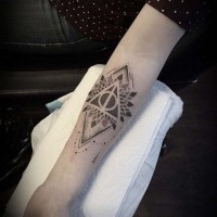Little black ink mystical forearm tattoo of geometrical flower and pyramid