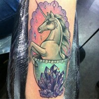 Little cartoon like colored unicorn in cup tattoo stylized with space