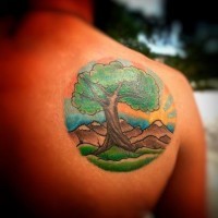 Little colorful big lonely tree tattoo on shoulder stylized with mountains