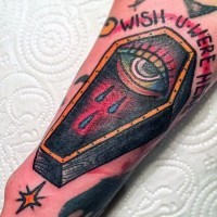 Little colorful mystic coffin with lettering tattoo on arm