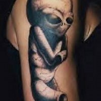 Little gray alien crippled on shoulder tattoo