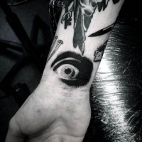 Kleines erschreckendes schwarzes  Auge Tattoo am Handgelenk