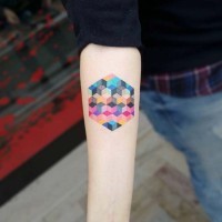 Little multicolored abstract geometrical tattoo on forearm