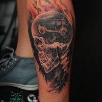 Little multicolored human skeleton tattoo on ankle with flames and car