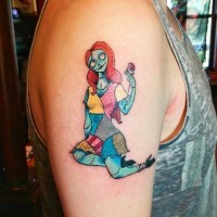Little multicolored romantic monster doll with flower tattoo on upper arm