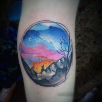 Little multicolored sunset with mountains tattoo on elbow