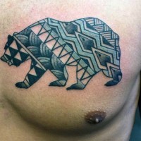 Little multicolored tribal style painted bear tattoo on chest