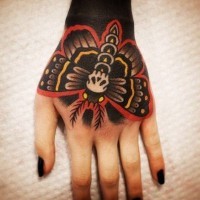 Little mystical colored hand tattoo of night butterfly stylized with skull