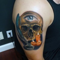 Little mystical pained colored skull with one eye and candles shoulder tattoo