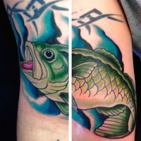 Little natural colored underwater fish tattoo on arm