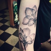Little natural looking black ink forearm tattoo of transparent flowers