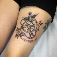 Little nautical themed colorful compass with bird tattoo on thigh stylized with flowers and lettering