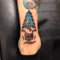 Little old school style antic arrow head tattoo on ankle stylized with mountains and moon