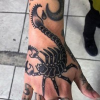 Little old school style painted black ink scorpion tattoo on hand