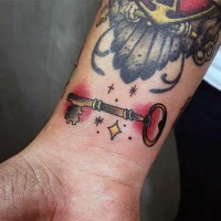 Little old style antic colored key tattoo on wrist