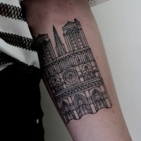 Little simple black ink tattoo on forearm of old cathedral