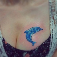Little simple painted cute dolphin tattoo on chest