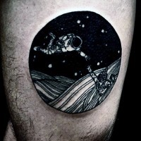 Little space themed black and white round tattoo on thigh