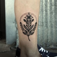 Little very beautiful black ink flower tattoo on leg muscle