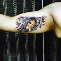 Little very realistic colored fantasy dragon eye tattoo on arm