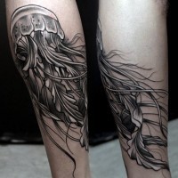 Little very realistic looking black and white jellyfish tattoo on leg