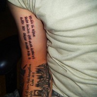 Long black hebrew tattoo on arm