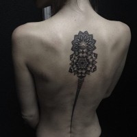 Long original painted black ink tribal tattoo on spine area