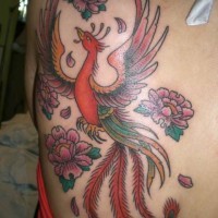 Lovely flying phoenix and flowers tattoo on back