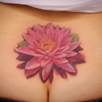 Lovely red lotus tattoo on lower back