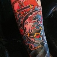 Mad shark and roped anchor in water waves in sun rise colored tattoo in old school style